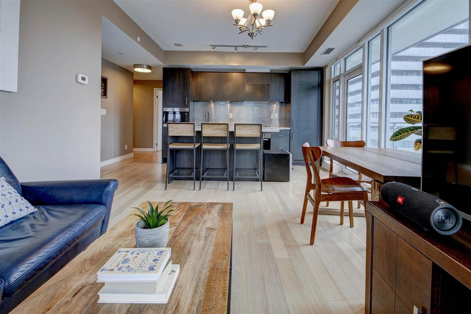 Modern condo interior with open kitchen and city views